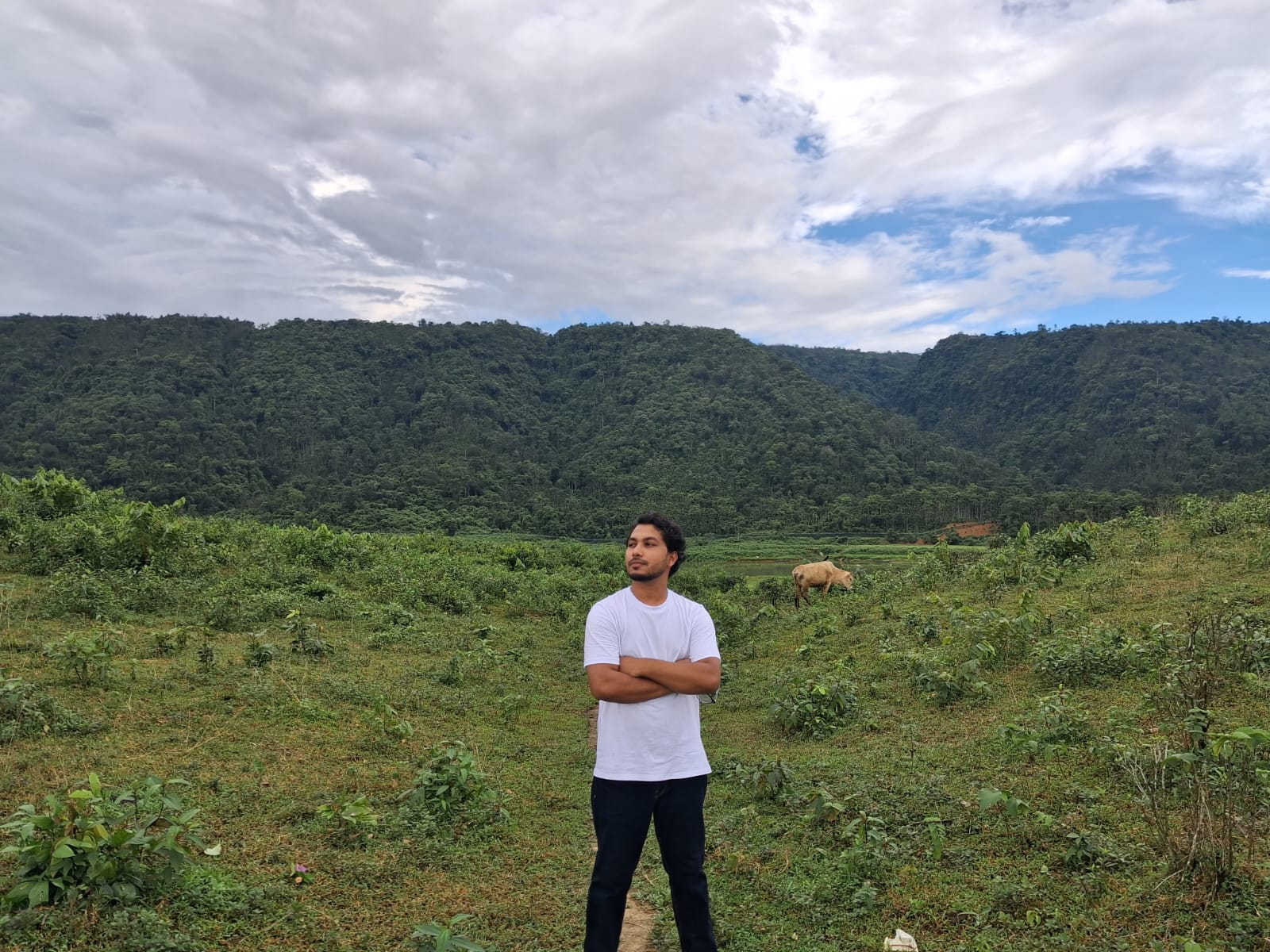 Sayem Ahmed Shayeed standing outdoors in a green landscape